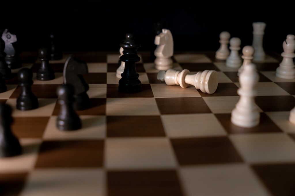 Fallen king on chessboard after a game