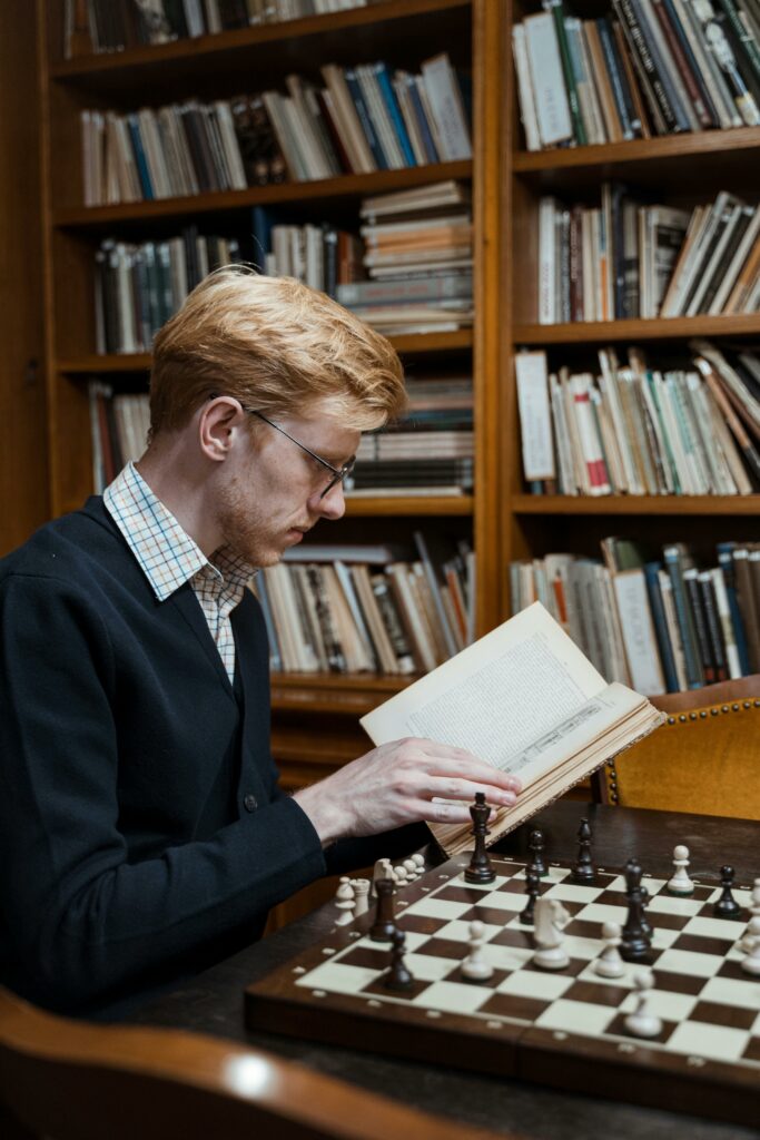 Young man studying chess