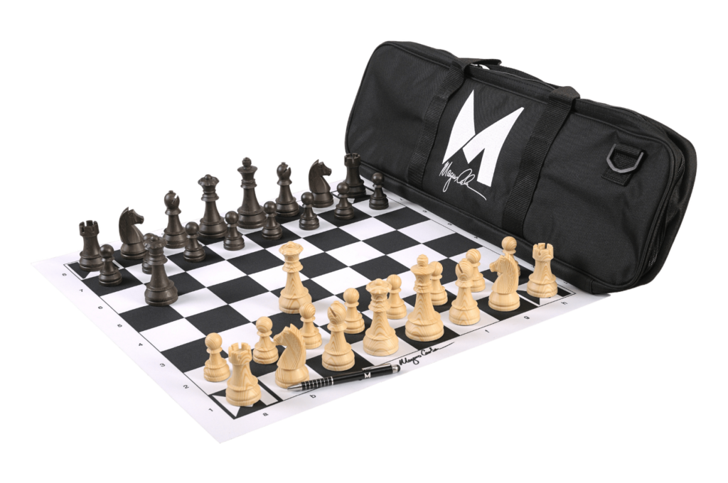 Chess set with black and white pieces next to a Magnus Carlsen signed bag